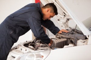 Mechanic working on car engine 